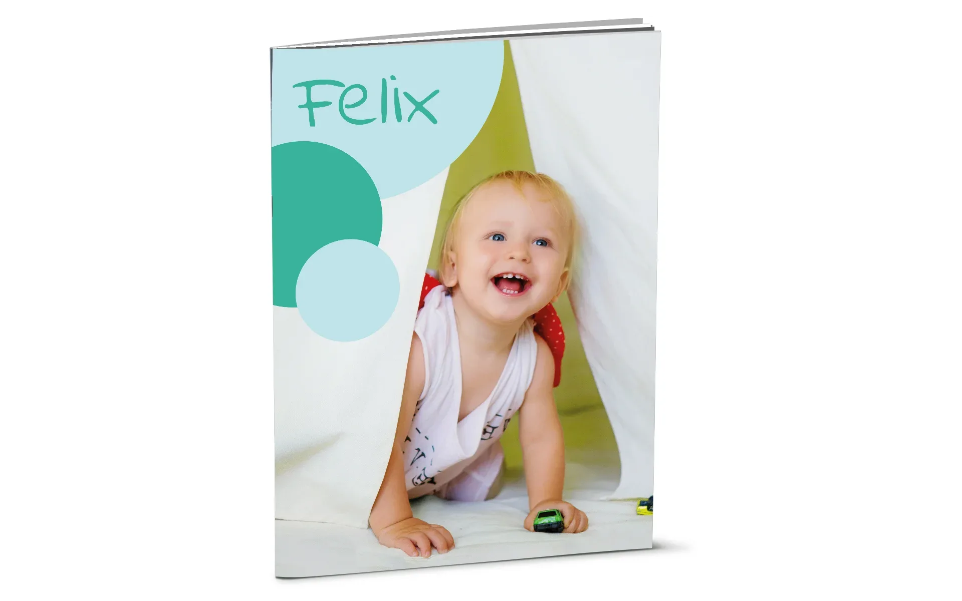 Happy Fotobuch ca. A4 hoch Ein aufgestelltes Happy Fotobuch ca. A4 hoch mit dem Titel Felix zeigt ein Baby.